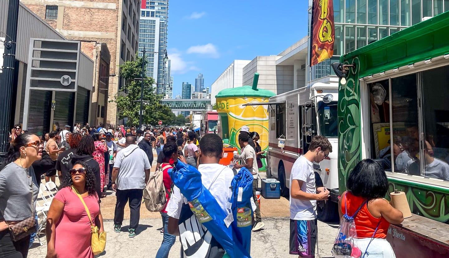 group of people walking at a food truck festival